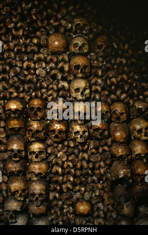 Wall made of skulls at the Catacombs of Paris an underground ossuaries which hold the remains of slightly less than 2 million people in a small part of a tunnel network built to consolidate Paris' ancient stone mines Extending south from the Barrière d'Enfer ('Gate of Hell') former city gate in Paris France Stock Photo