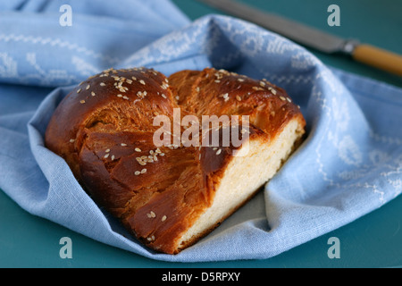 Loaf of sweet challah bread with napkin and knife Stock Photo