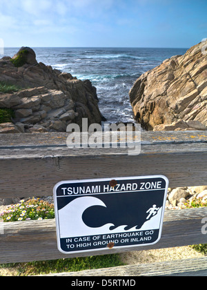 Tsunami earthquake hazard zone sign on coastal 17 mile drive Pacific Grove Monterey California USA Stock Photo