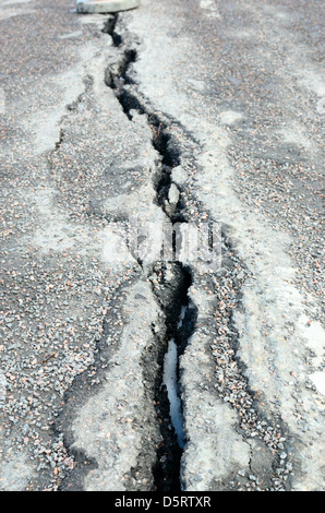 long crack stretching cross the sidewalk, vertical Stock Photo