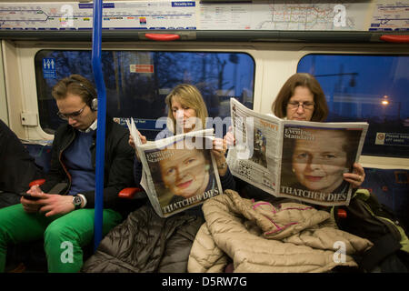 London, UK. 8th April, 2013.  Londonders on The Underground read of the death of ex-British Prime Minister, Baroness Margaret Thatcher whose death was announced on April 8th, 2013 in London. Thatcher (known to Britons as Maggie) served as leader of the Conservative party then Prime Minister of Britain from 1979 to 1990 and passed away from a stroke at age 87. Credit: Richard Baker/Alamy Live News Stock Photo