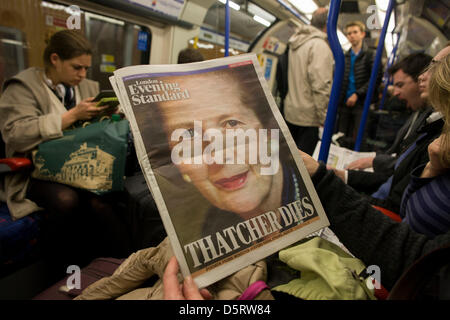 London, UK. 8th April, 2013.  Londonders on The Underground read of the death of ex-British Prime Minister, Baroness Margaret Thatcher whose death was announced on April 8th, 2013 in London. Thatcher (known to Britons as Maggie) served as leader of the Conservative party then Prime Minister of Britain from 1979 to 1990 and passed away from a stroke at age 87. Credit: Richard Baker/Alamy Live News Stock Photo