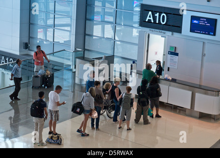 Check-in queue line Airline passengers waiting to check in to board flight at concourse gate A10 San Francisco Airport International California USA Stock Photo