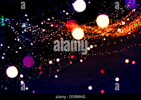 Abstract blurred background with orange lights bokeh in the dark Stock Photo