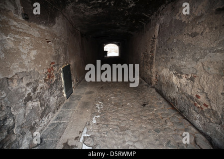 Old dark stone gateway perspective with glowing end. Tallinn, Estonia Stock Photo