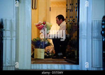London,UK. 8th April 2013. Flower tributes are collected and brought inside the residence of Margaret Thatcher in Chester Square. The former Prime Minister died today at the age of 87. Credit: Piero Cruciatti / Alamy Live News Stock Photo