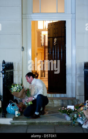 London,UK. 8th April 2013. Flower tributes are collected and brought inside the residence of Margaret Thatcher in Chester Square. The former Prime Minister died today at the age of 87. Credit: Piero Cruciatti / Alamy Live News Stock Photo