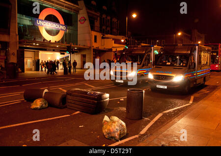 London, UK. 8th April 2013. Protesters litter the road with up-turned bins as celbrations turned sour and protesters blocked the road. Bottles were thrown at police wearing helmets Stock Photo