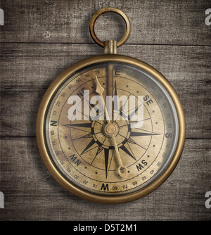 old brass compass on wood table top view Stock Photo