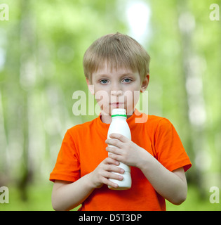 Cute child holding bottle with milk Stock Photo