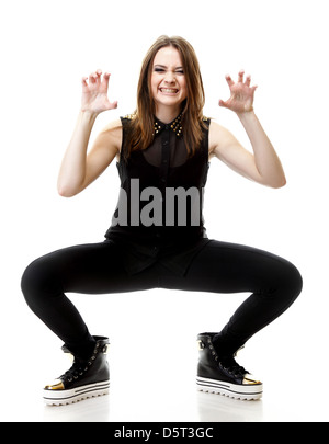 Grimacing. Full length young angry woman making silly face on white background Stock Photo
