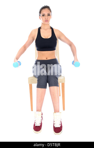 Determined Confident Positive Young Woman Performing Tricep Extensions Exercises Sitting On Chair Isolated Against A White Background With Copy Space Stock Photo