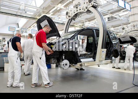 (dpa Files) - An archive picture, dated 7 March 2012, shows workes of car manufactuerer Volkswagen (VW) working on a Tiguan car model at the car manufactuing plant in Wolfsburg, Germany, 7 March 2012. The EU-debt crisis is hindering Germany's economic situation. The gross domestic product (GDP) increased by 0.2 per cent only in the third quarter of the 2012 business year in compari Stock Photo