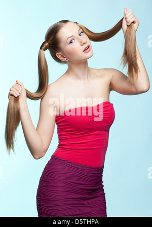 Freckled girl in red dress Stock Photo