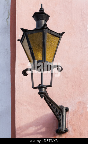 Old Lantern on a pink building wall in Tallinn, Estonia Stock Photo