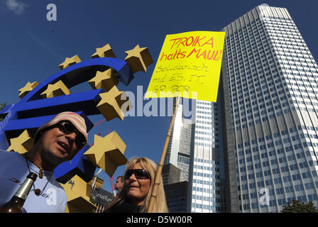 Protesters are pictured at the European Central Bank headquarters in Frankfurt, Germany, 29 September 2012. In the course of the Germany-wide action day under the motto 'Fair share - tax on wealth', the organisation Attac, work unions and social organisations had called for a protest day. Central demands are among others a permanent tax on wealth and a one-time concession tax as we Stock Photo
