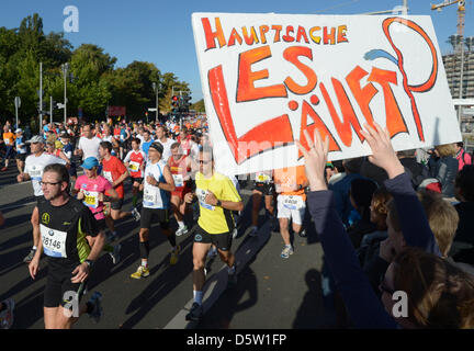 A field of runners is cheered on by the audience after the start of the 39th Berlin Marathon on Strasse des 17. Juni in Berlin, Germany, 30 September 2012. About 41 000 participants have registered for the 42,195 track that leads them across the German capital. Photo: Rainer Jensen Stock Photo