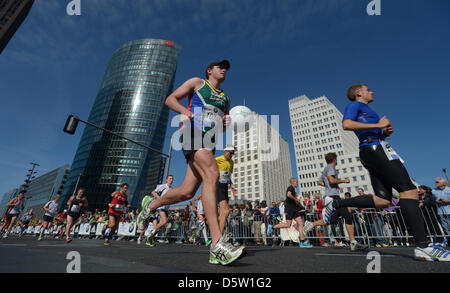 A field of runners passes Potsdamer Platz in the course of the 39th Berlin Marathon in Berlin, Germany, 30 September 2012. About 41 000 participants have registered for the 42,195 track that leads them across the German capital. Photo: Rainer Jensen Stock Photo