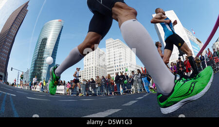 A field of runners passes Potsdamer Platz in the course of the 39th Berlin Marathon in Berlin, Germany, 30 September 2012. About 41 000 participants have registered for the 42,195 track that leads them across the German capital. Photo: Rainer Jensen Stock Photo