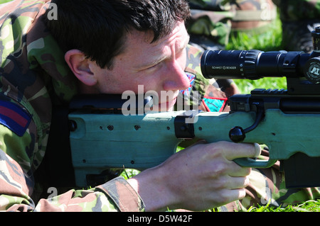 British infantry soldier is seen looking down the telescopic sight of the new British-made long range L115A3 sniper rifle Stock Photo