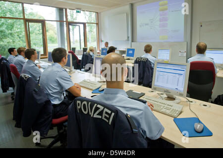 Police officer trainees take part in a class at the training and ...