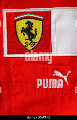 Puma and Scuderia Ferrari racing shield  logos on red top Stock Photo