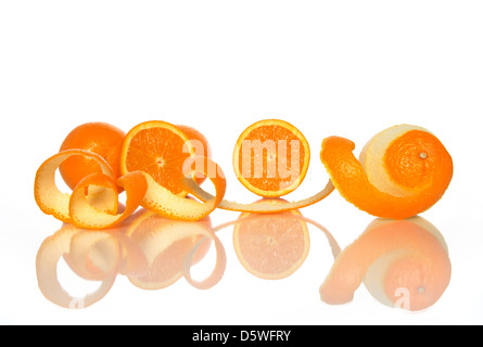 Tasty oranges and spiral orange peel reflecting on white background. Stock Photo