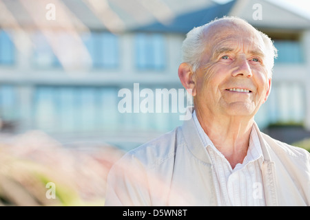 Smiling older man standing outdoors Stock Photo