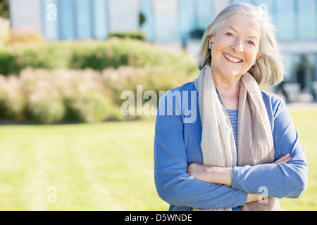 Smiling older woman standing outdoors Stock Photo - Alamy