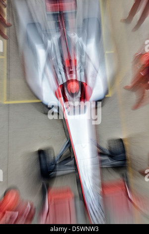 Blurred view of race car on track Stock Photo
