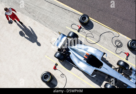 Racer walking to car in pit stop Stock Photo
