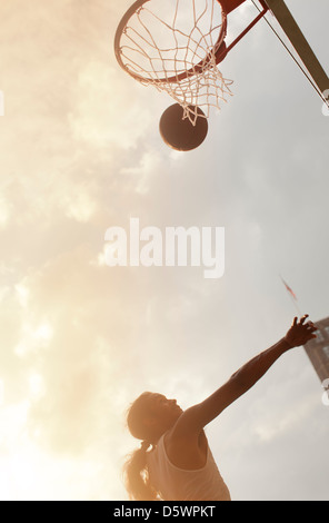 Man playing basketball on court Stock Photo