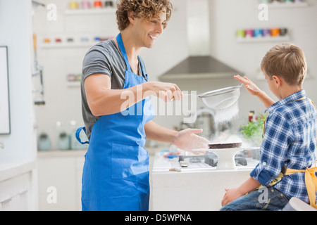 Father and son baking in kitchen Stock Photo
