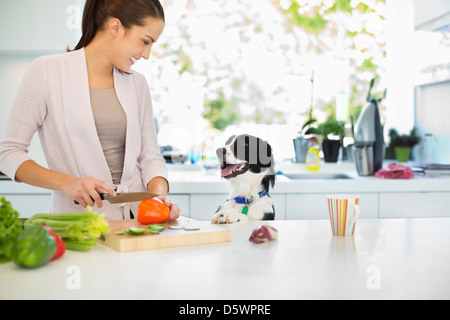 Woman chopping vegetables in kitchen Stock Photo