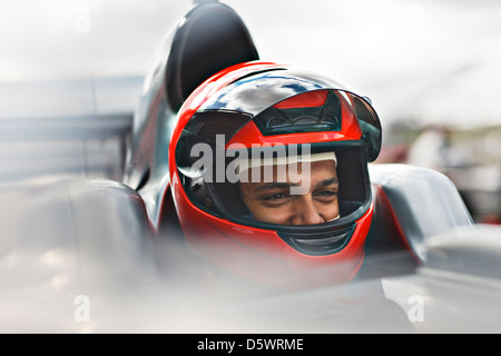 Racer sitting in car on track Stock Photo