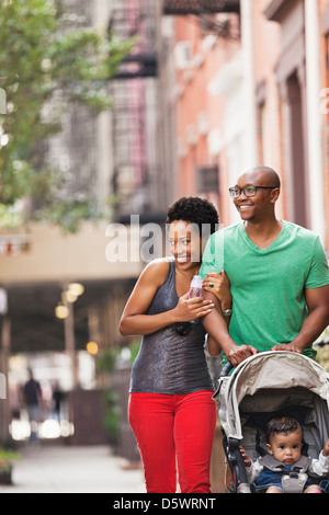 Family walking together on city street Stock Photo