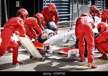 Racing team working at pit stop Stock Photo