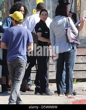 Lucy Liu dresses as a police officer on the set of the television show 'Southland' Los Angeles, California - 08.02.12 Stock Photo