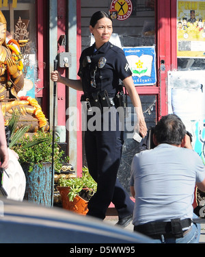 Lucy Liu dresses as a police officer on the set of the television show 'Southland' Los Angeles, California - 08.02.12 Stock Photo