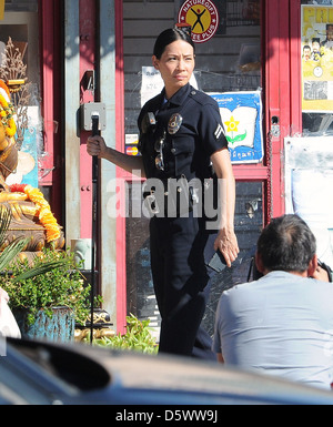 Lucy Liu dresses as a police officer on the set of the television show 'Southland' Los Angeles, California - 08.02.12 Stock Photo