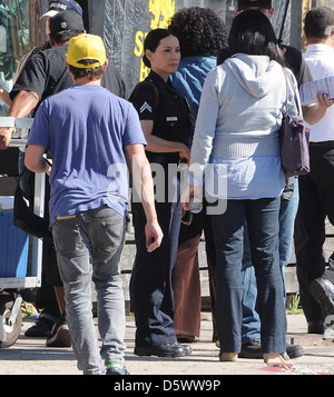 Lucy Liu dresses as a police officer on the set of the television show 'Southland' Los Angeles, California - 08.02.12 Stock Photo