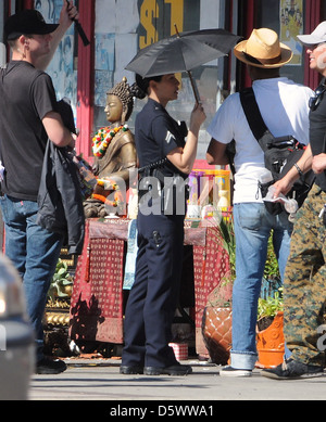 Lucy Liu dresses as a police officer on the set of the television show 'Southland' Los Angeles, California - 08.02.12 Stock Photo