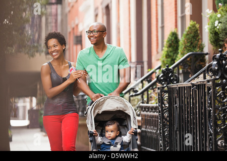 Family walking together on city street Stock Photo
