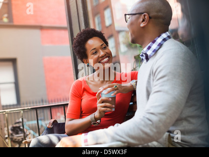 Couple talking on city street Stock Photo