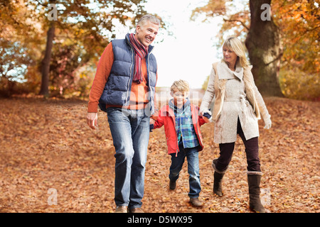 Older couple walking with grandson in park Stock Photo