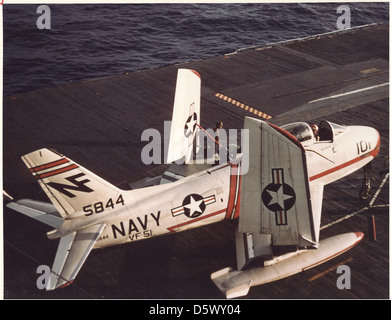 North American FJ-3 (F-1C) 'Fury' of VF-51 is on the deck of the USS ESSEX (CVA-9) being pushed by the crew onto the catapult of the flight deck ready to launch. Stock Photo