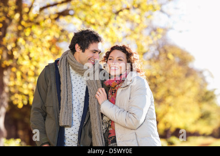 Couple walking together in park Stock Photo