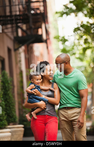 Family walking together on city street Stock Photo