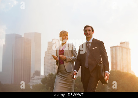 Business people walking in urban park Stock Photo