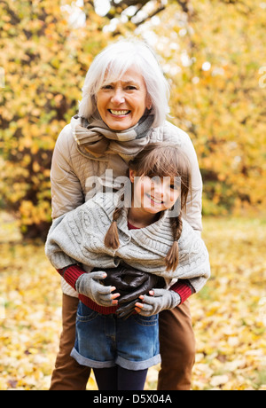 Woman and granddaughter hugging in park Stock Photo